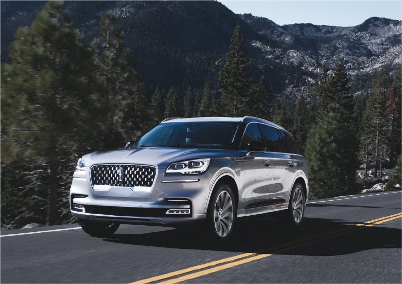 A 2023 Lincoln Aviator® Grand Touring SUV being driven on a winding road to demonstrate the capabilities of all-wheel drive | Biondi Lincoln in Monroeville PA