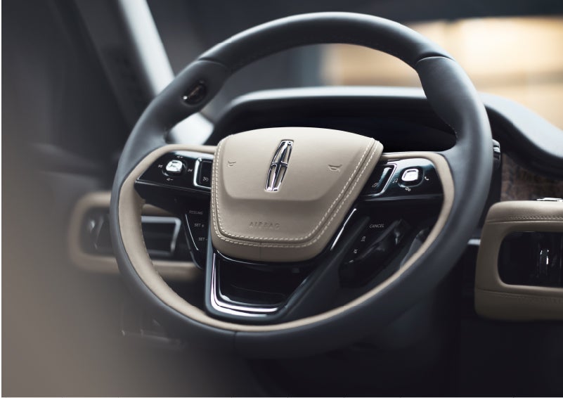The intuitively placed controls of the steering wheel on a 2023 Lincoln Aviator® SUV | Biondi Lincoln in Monroeville PA