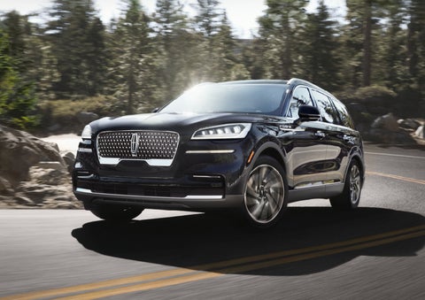 A Lincoln Aviator® SUV is being driven on a winding mountain road | Biondi Lincoln in Monroeville PA