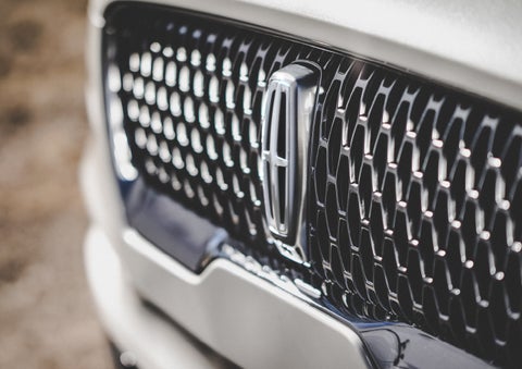 The grille of the 2024 Lincoln Aviator® Reserve model with an eye-catching repeated field of Lincoln Star logo shapes | Biondi Lincoln in Monroeville PA