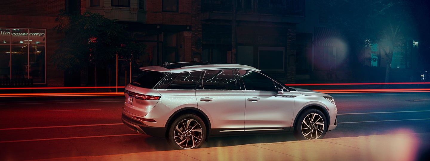 The 2024 Lincoln Corsair® SUV is parked on a city street at night. | Biondi Lincoln in Monroeville PA