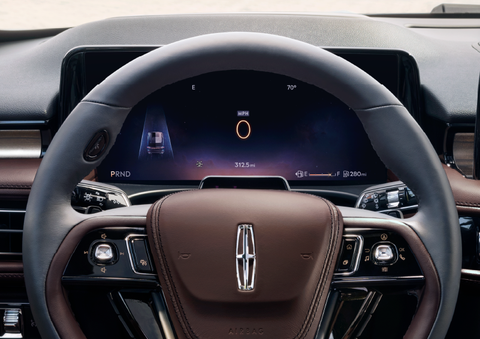 The steering wheel of 2025 Lincoln Aviator® SUV is shown with black and brown accents. | Biondi Lincoln in Monroeville PA