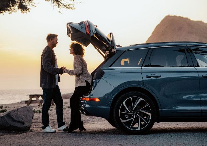 A couple share a moment together outside a 2025 Lincoln Corsair® SUV near the open liftgate. | Biondi Lincoln in Monroeville PA