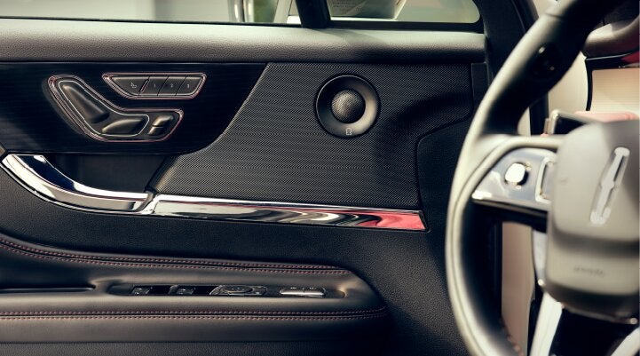 A Revel® audio speaker is shown in the driver's side door of a 2025 Lincoln Corsair® SUV. | Biondi Lincoln in Monroeville PA