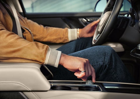 The driver of a 2024 Lincoln Corsair® SUV is shown selecting the drive mode. | Biondi Lincoln in Monroeville PA