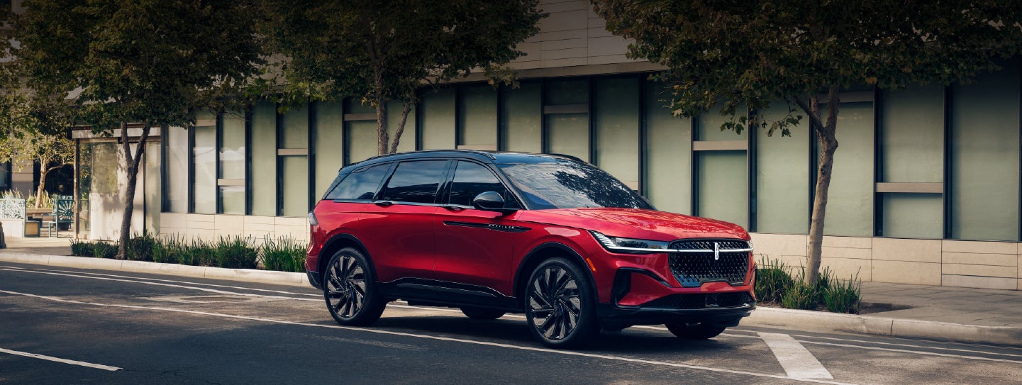 A 2025 Lincoln Nautilus® SUV with an available hybrid powertrain is parked in an urban setting. | Biondi Lincoln in Monroeville PA