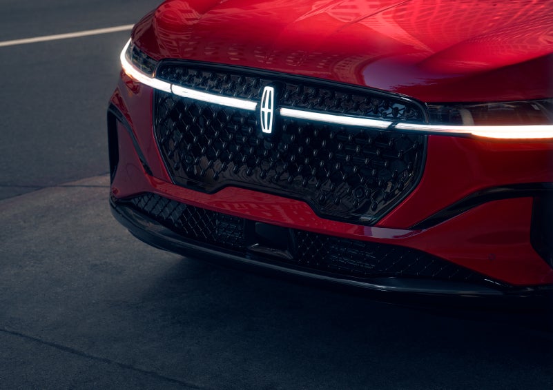 The available front LED light bar and center Lincoln Star logo glow at dusk. | Biondi Lincoln in Monroeville PA