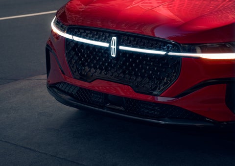 The available front LED light bar and center Lincoln Star logo glow at dusk. | Biondi Lincoln in Monroeville PA