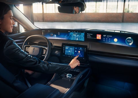The driver of a 2025 Lincoln Nautilus® SUV interacts with the center touchscreen. | Biondi Lincoln in Monroeville PA