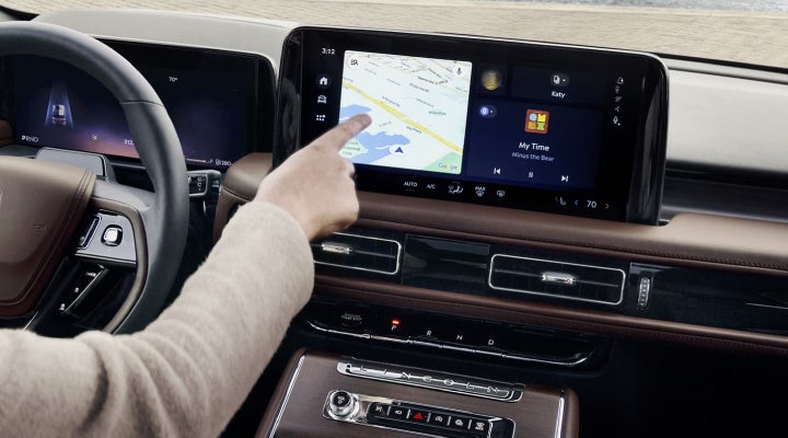A person is tapping the center display touchscreen of a 2026 Lincoln Aviator® SUV. | Biondi Lincoln in Monroeville PA