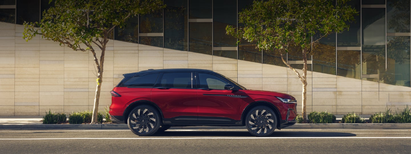 A 2026 Lincoln Nautilus® SUV with an available Hybrid Powertrain is parked in an urban setting. | Biondi Lincoln in Monroeville PA