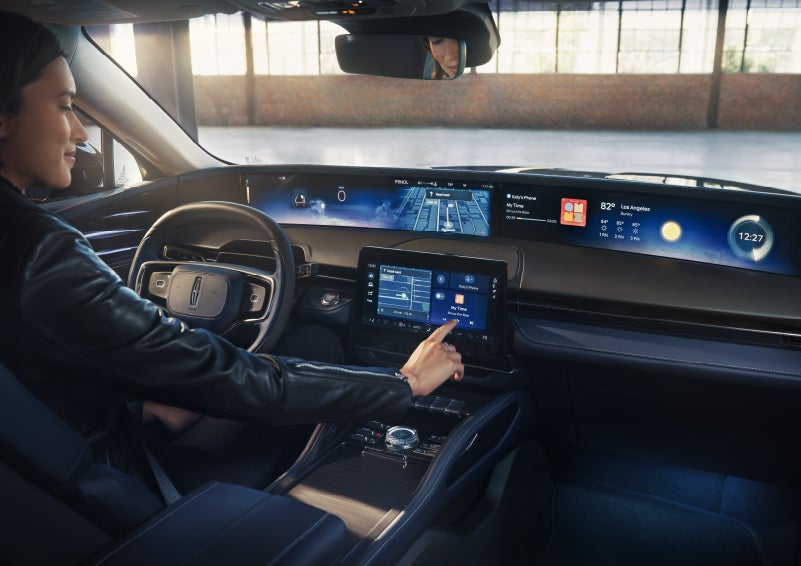 The driver of a 2026 Lincoln Nautilus® SUV interacts with the center touchscreen. | Biondi Lincoln in Monroeville PA