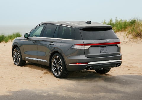 A 2027 Lincoln Aviator® SUV is parked next to sand dunes. | Biondi Lincoln in Monroeville PA