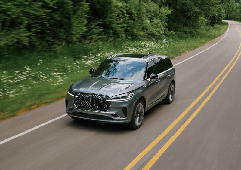 A 2027 Lincoln Aviator® SUV is being driven down a road. | Biondi Lincoln in Monroeville PA