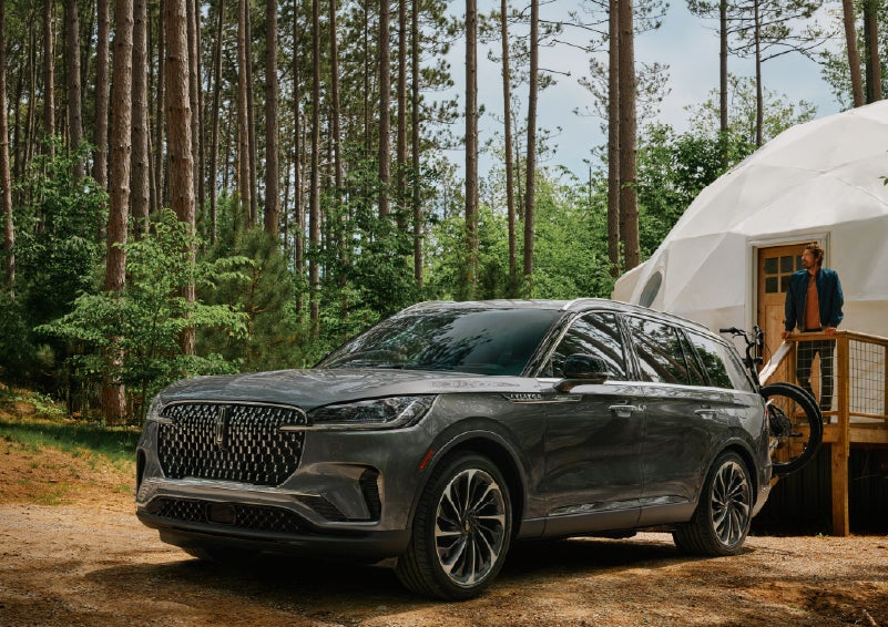 A 2027 Lincoln Aviator® is parked next to a high end glamping site. | Biondi Lincoln in Monroeville PA