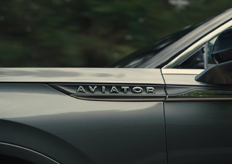 The driver’s side door and fender badging of a gray 2027 Lincoln Aviator® SUV are showcased. | Biondi Lincoln in Monroeville PA