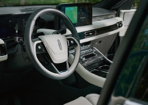 The leather-trimmed steering wheel of a 2027 Lincoln Aviator® Black Label™ SUV. | Biondi Lincoln in Monroeville PA