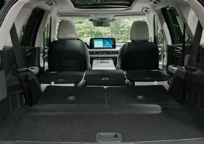 A rear to front view of the interior of a 2027 Lincoln Aviator® Black Label™ SUV shows the third and second rows folded flat | Biondi Lincoln in Monroeville PA