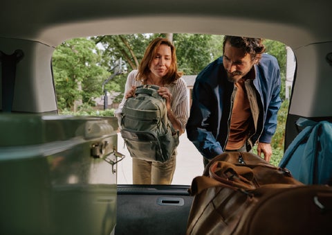 A couple loads luggage into the rear of a 2027 Lincoln Aviator® Black Label™ SUV..e 202 | Biondi Lincoln in Monroeville PA